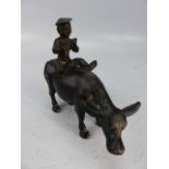 Bronze Buffalo with piper seated on its back possibly oriental/Chinese