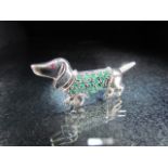 Sterling silver brooch in the form of a Dachshund set with green stones
