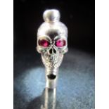 Silver Skull whistle set with Ruby eyes.