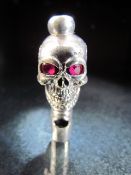 Silver Skull whistle set with Ruby eyes.