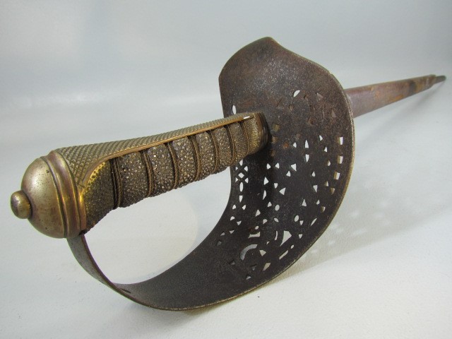 Antique officers sword with carved metal hilt and sharkskin handle. Leather scabbard A/F