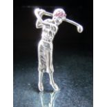 Silver brooch in the form of a lady Golfer set with red stones