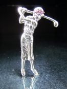 Silver brooch in the form of a lady Golfer set with red stones