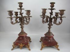 French pair of Rococo style candleabras on marble stepped base and ormolu feet. Five armed cast