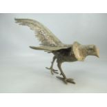 Silver coloured figure of an ornamental cock pheasant