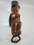 Vintage bottle opener with wooden carving of a gentleman with bow tie & top hat