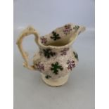 Early Staffordshire transfer ware jug - marked 'Grotto' to base. Decorated in Greens and Purples