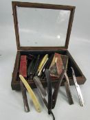 Wooden & Glass presentation case containing approx fifteen various cut throat razors