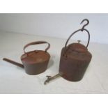 Large Cast iron kettle with bath water tap along with one other large copper kettle.