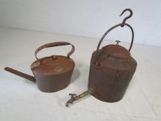 Large Cast iron kettle with bath water tap along with one other large copper kettle.