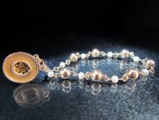 Gold Coloured bracelet with hanging circular Egyptian style pendant. approx total weight - 8.1