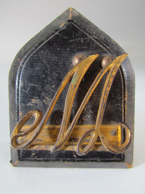 Early Victorian Shield shaped plaque bound with leather. The W making a paperclip.