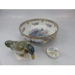 Oriental style bowl decorated with birds and flowers along with a Royal Doulton duck and one other