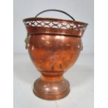Antique Copper Wine Cooler with pierced top and Lion head handles.
