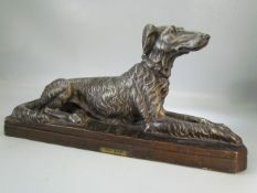 French figure of a recumbent dog by Floro. 'Chien Levrier, Per Floro'.