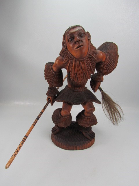 Indonesian style carved wooden figure of a warrior man in full dress