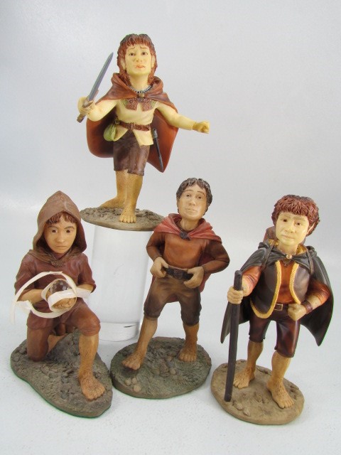 Lord of the Rings Collectables - Four unmarked figures of the hobbits.