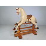 Antique Cremello style coloured rocking horse on antique wooden base