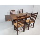 Antique oak dining table with matching rush seated chairs