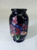 Moorcroft miniature vase decorated with flowers and tube design.