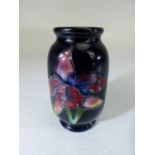 Moorcroft miniature vase decorated with flowers and tube design.