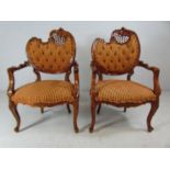 Oriental style pair of chairs with Rococo scroll tops decorated with Acanthus leaves and fretwork.