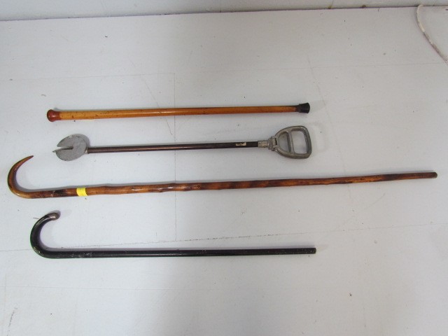 Hallmarked silver topped walking stick along with a shooting stick and two others