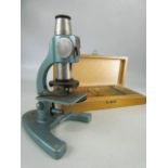 Small unmarked microscope along with a set of slides