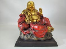 Large wooden and gold figure of Buddha on plinth