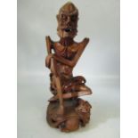 Chinese style carved wooden figure of an elder. Signed to base