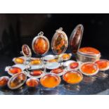 Collection of Amber on Silver Jewellery consisting of Brooches, bracelets, earrings and an Amber