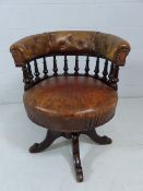 Antique turned mahogany and leather captains chair with galleried frame leading to button back