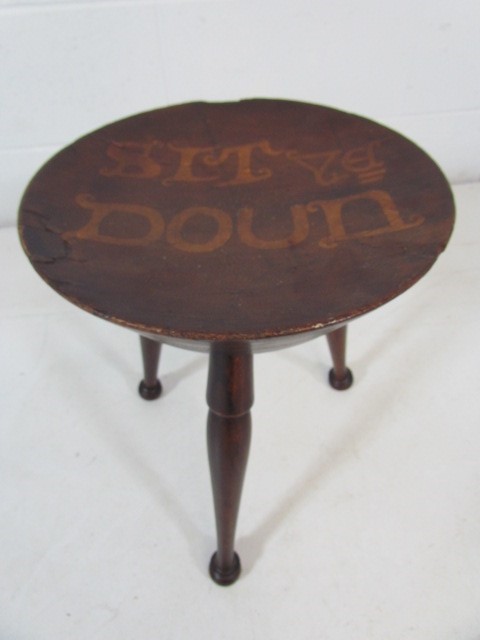 Antique turned wooden stool with writing to seat 'Sit ye Down'