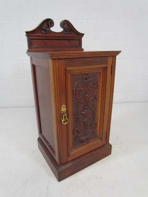 Mahogany carved pot cupboard with Fleur de lis style design to front