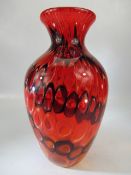 Unusual glass bulbous vase decorated in red and sunset colours