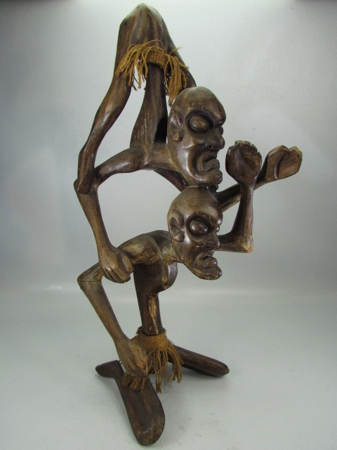 Carved African/Indonesian figure of two stick man upon the shoulders of each other