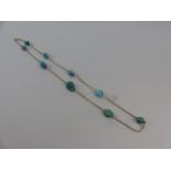9ct Gold Turquoise Necklace approx: 25” long. The facetted trace link chain is set with 9 natural