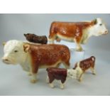 Collection of porcelain cows to include Beswick