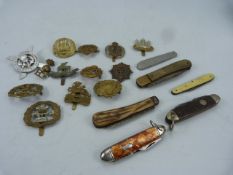 Collection of military badges and penknives