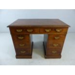 Kneehole desk with leather top and brass fittings