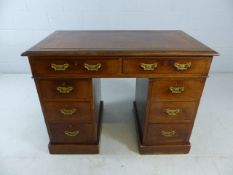 Kneehole desk with leather top and brass fittings