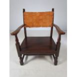 Low wooden nursing chair with leather weaved back