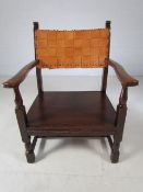 Low wooden nursing chair with leather weaved back