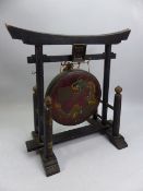 Chinese gong on wooden ebonised stand, the gong with painted dragon