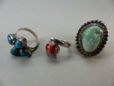 Three silver rings set with various stones