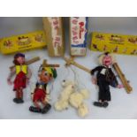 Four Pelham puppets with boxes to include a White Poodle, Cowgirl, Schoolmaster, Pinocchio