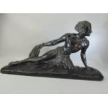 Art deco style plaster figurine of man reclining on a rock holding a rope, marked C Meurice and to