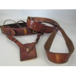 Two Sam Browne belts, one with sword holster and etched with name of soldier