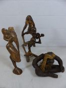 A carved African/Indonesian figure of two stick men, a carved figure of an Elephant on pedestal foot