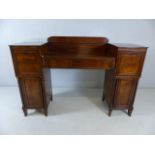 Regency sideboard in flame mahogany with original key. Twin pedestal, one with claret drawer with